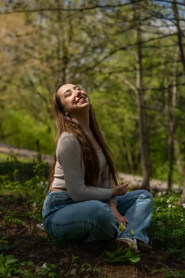 Woman laughing in a spring forest