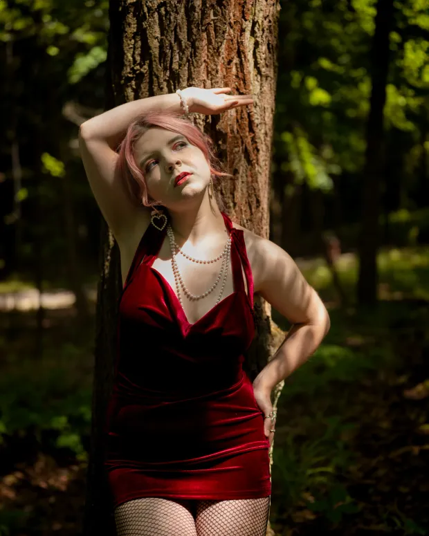 Woman in a red dress in the forest