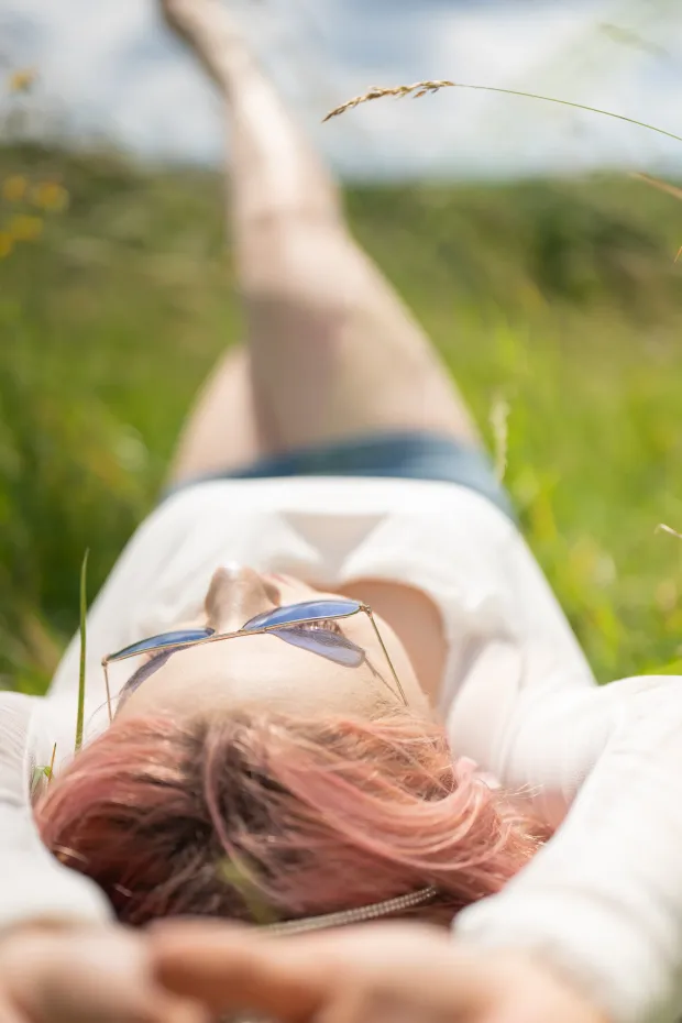Outdoor female session in a meadow — woman in the grass